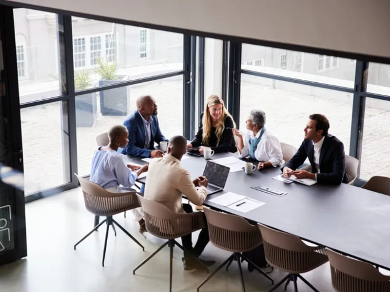 Work team meeting at a conference table.