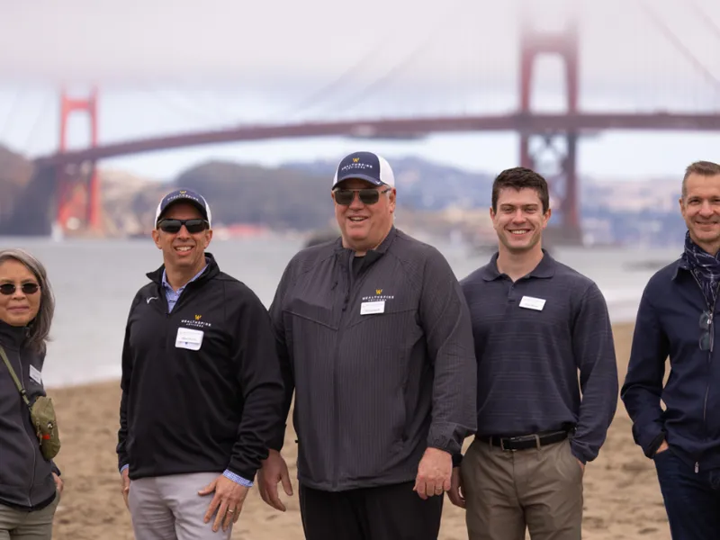 colleagues posing on beach