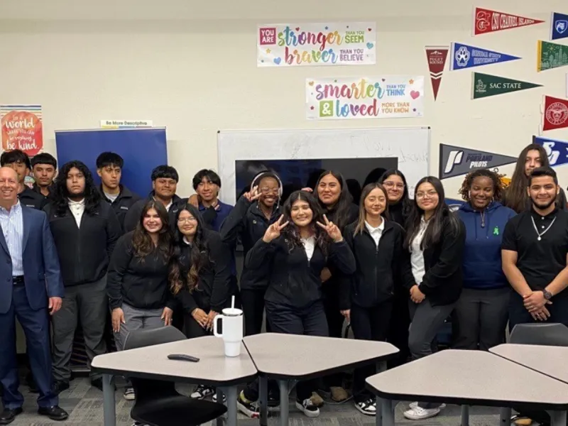group of students smiling in classroom